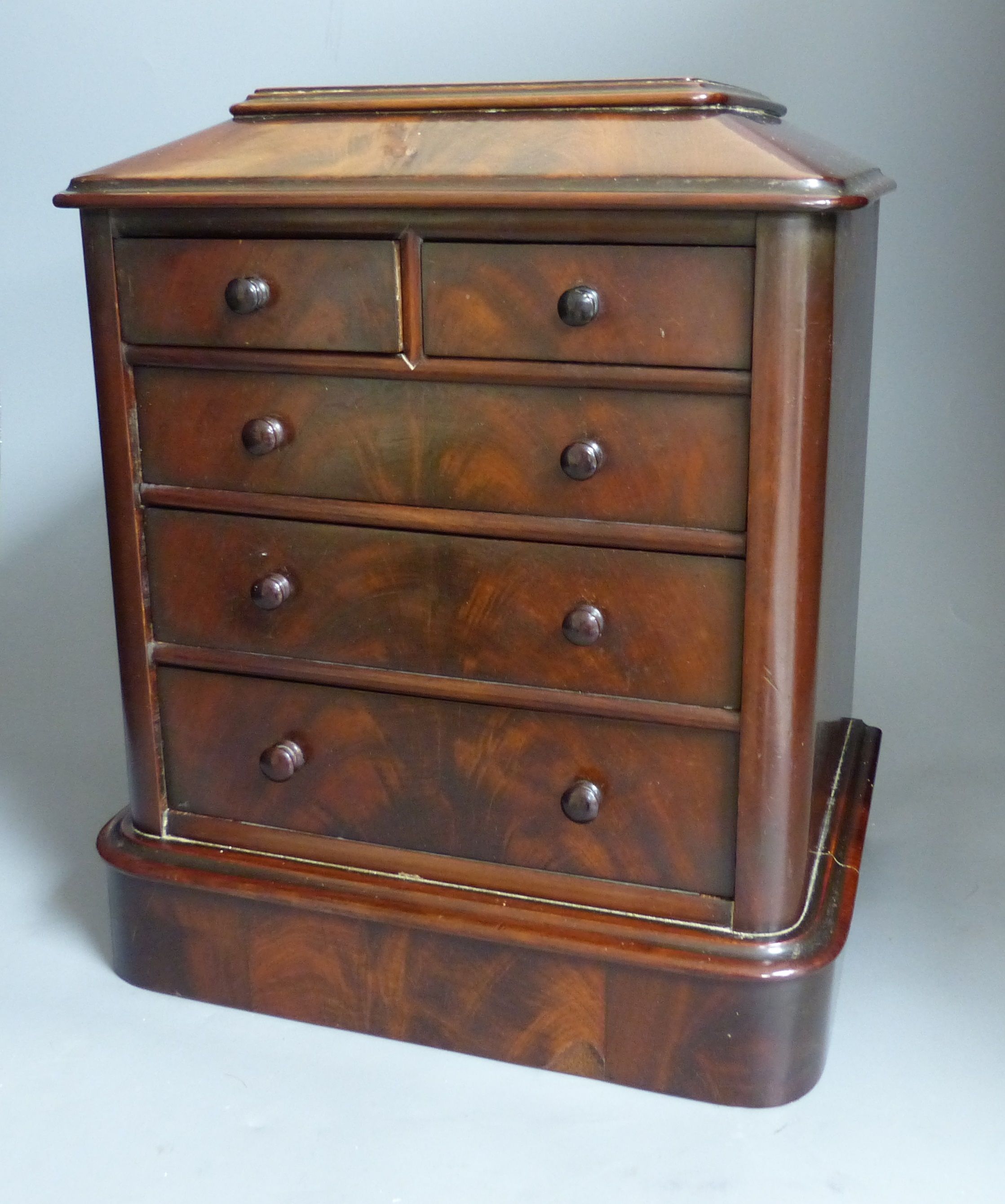 A Victorian miniature mahogany table top chest of drawers, height 35cm